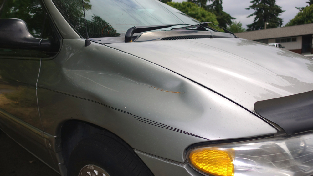 Car hood with a visible dent